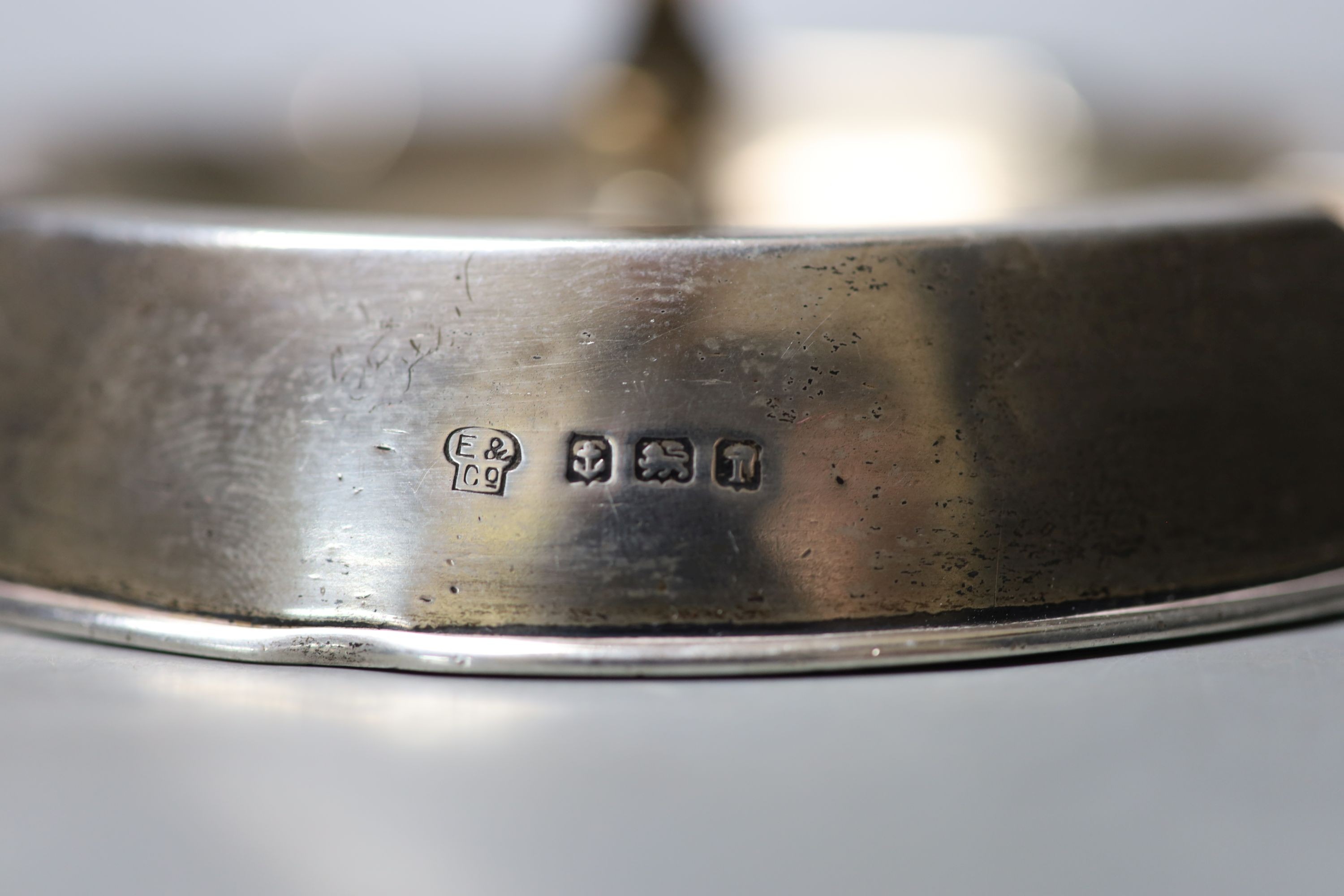 An Edwardian silver mounted combination ashtray/candlestick, Birmingham, 1908, diameter 14.4cm, weighted.